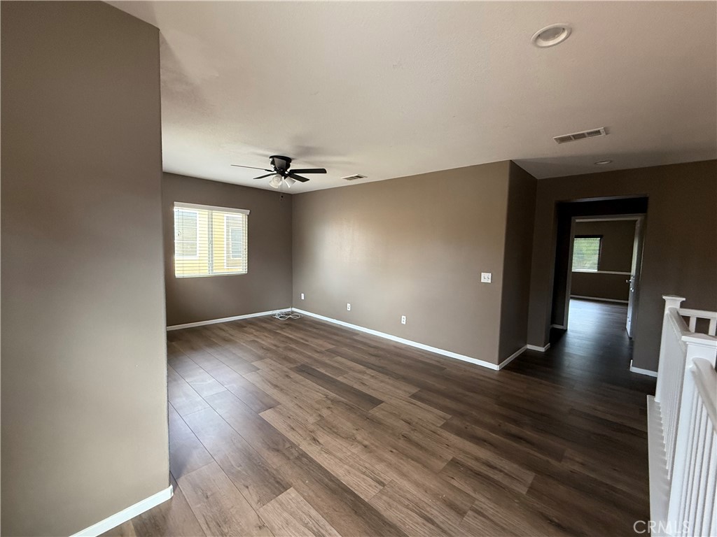 1264 Reisling Drive Perris, CA 92571 - Photo 14 of 15 a view of an empty room with window and wooden floor