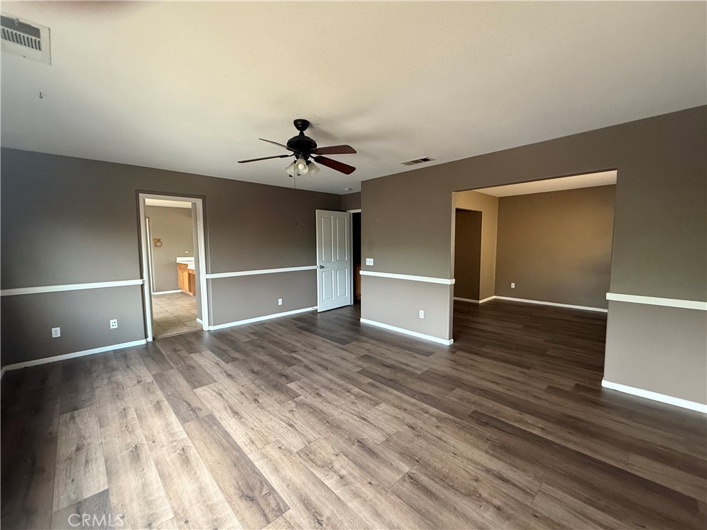 1264 Reisling Drive Perris, CA 92571 - Photo 8 of 15 a view of empty room with wooden floor