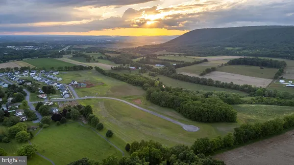 an aerial view of a houses with a yard