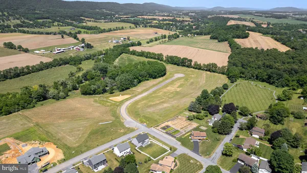 an aerial view of residential houses with outdoor space and river
