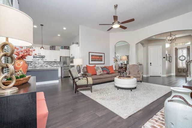 a living room with furniture and a wooden floor