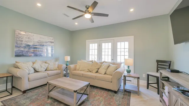 a living room with furniture and kitchen view