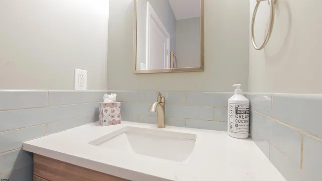 a bedroom with a bed and a flat tv screen on the dresser