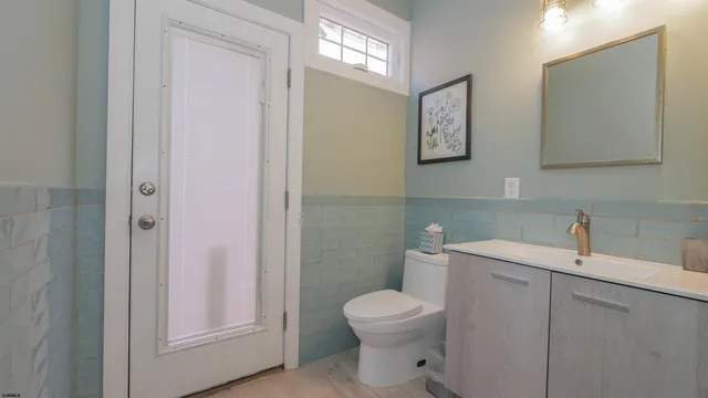 a white toilet sitting next to a bathroom sink
