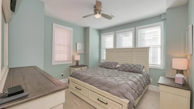 a bedroom with a bed and a lamp on table in it