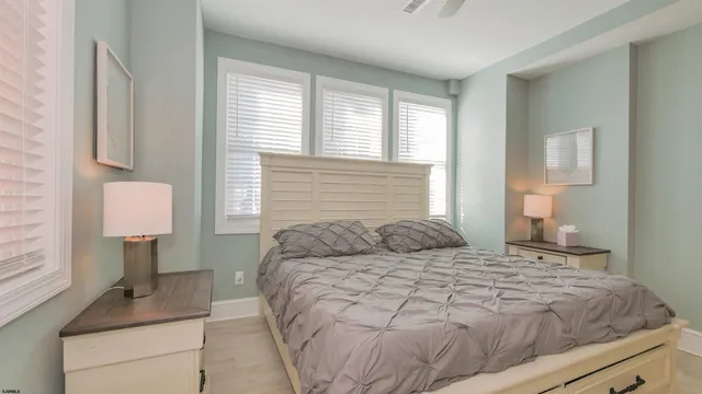 a bedroom with a bed a flat screen tv and view of bathroom