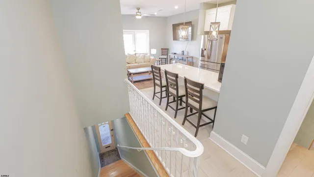 a kitchen with stainless steel appliances a table chairs and chandelier
