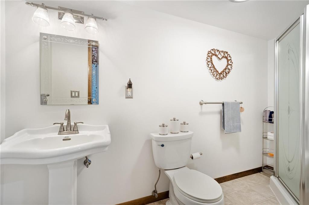 205 Ross Road Eighty Four, PA 15330 - Photo 20 of 25 a bathroom with a toilet sink vanity and mirror