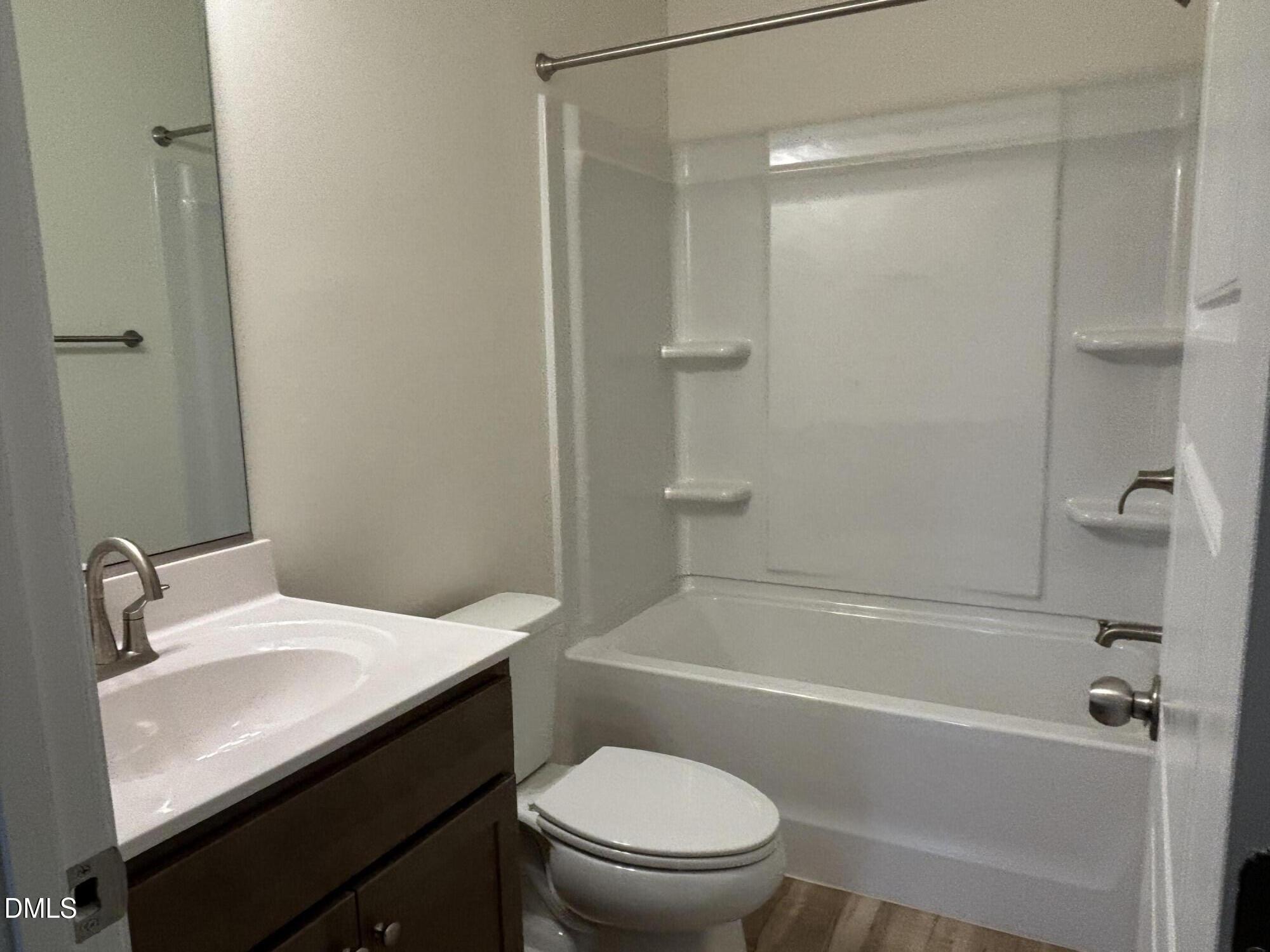 1917 Darrell Drive, Unit 5 Graham, NC 27253 - Photo 9 of 11 a bathroom with a sink a toilet and shower
