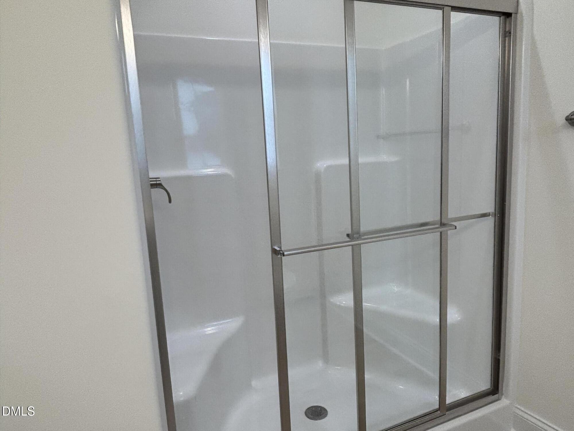 1917 Darrell Drive, Unit 5 Graham, NC 27253 - Photo 10 of 11 a bathroom with a glass shower door