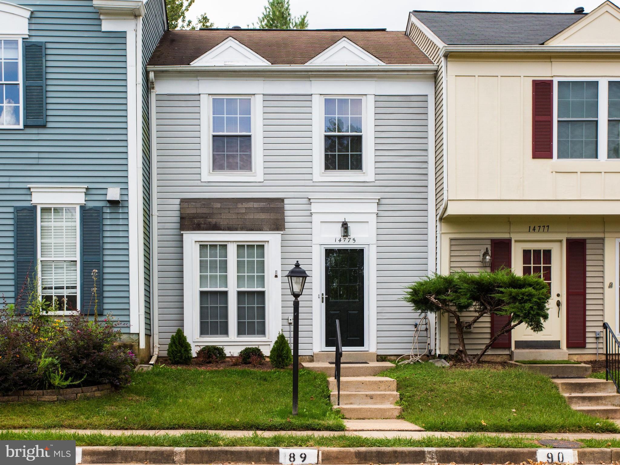 14775 Basingstoke Loop Centreville, VA 20120 - Photo 1 of 21 a front view of a house with a yard and potted plants