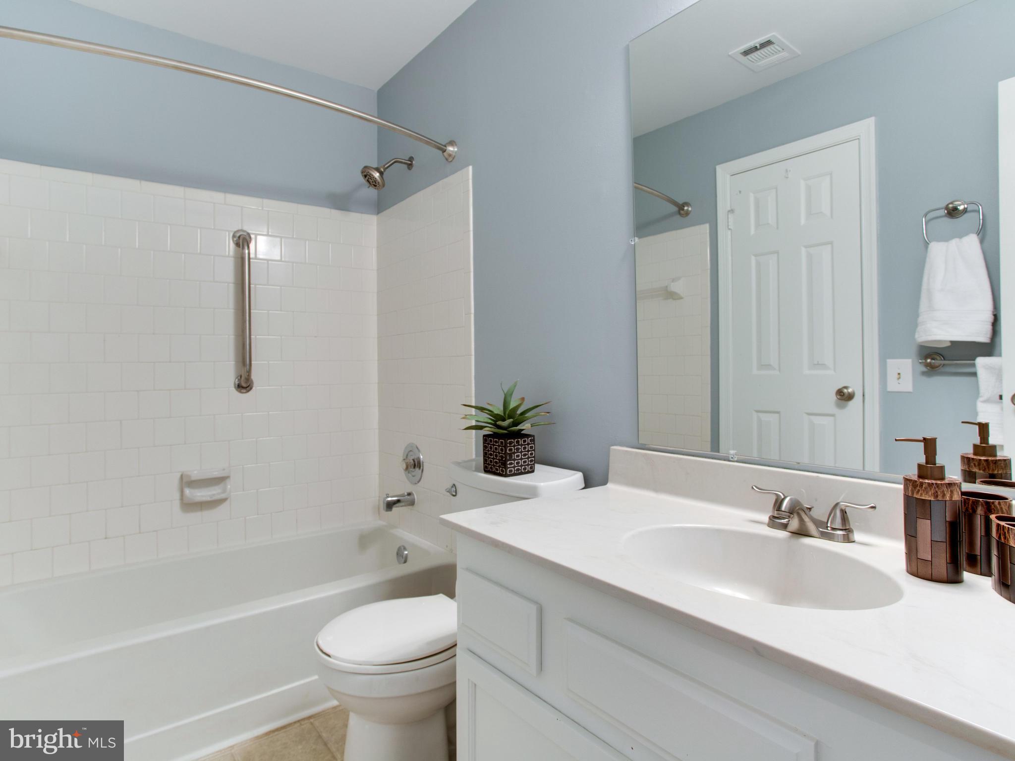 14775 Basingstoke Loop Centreville, VA 20120 - Photo 16 of 21 a bathroom with a granite countertop sink a toilet and shower