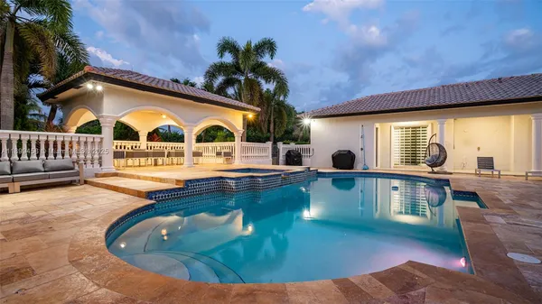 a kitchen with stainless steel appliances kitchen island granite countertop a stove a sink a dining table and chairs