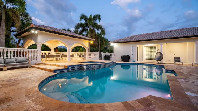 a kitchen with stainless steel appliances kitchen island granite countertop a stove a sink a dining table and chairs