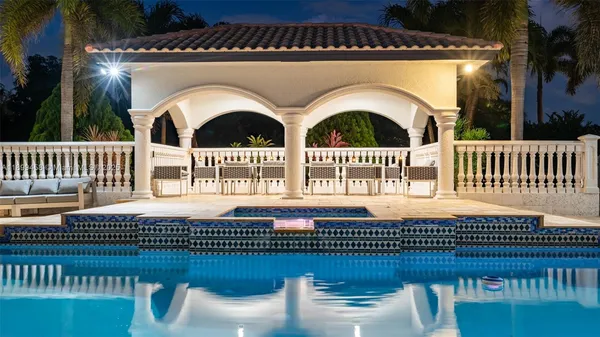 a kitchen with granite countertop a sink a stove and cabinets