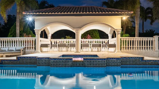 a kitchen with granite countertop a sink a stove and cabinets