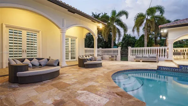 a living room with furniture kitchen and a table
