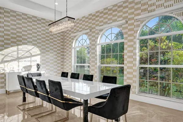 a living room with furniture a rug and a large window