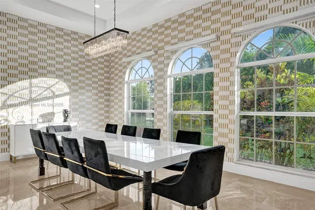 a living room with furniture a rug and a large window