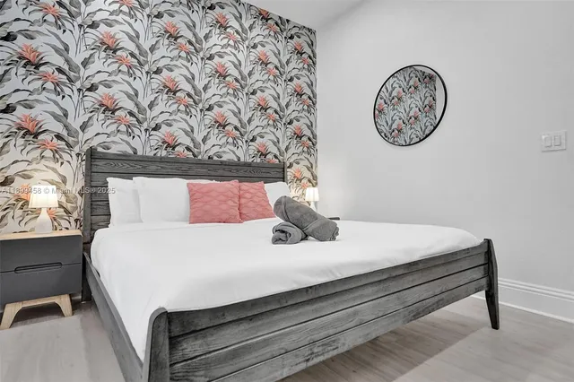 a spacious bedroom with two beds and a large window