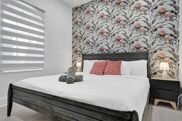 a spacious bedroom with two beds and a window