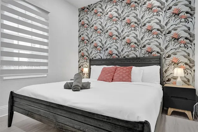 a spacious bedroom with two beds and a window