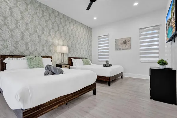 a bathroom with a granite countertop sink a toilet and a mirror