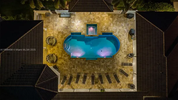 an aerial view of a house with yard and mountain view in back