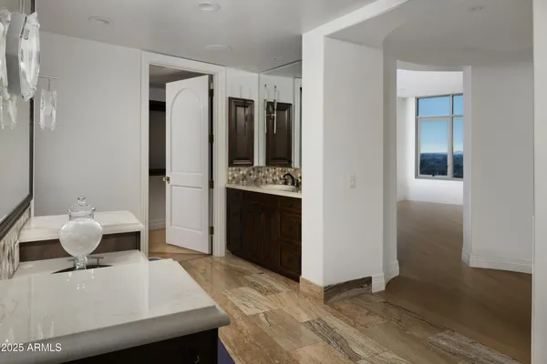 a living room with stainless steel appliances kitchen island granite countertop furniture and a refrigerator