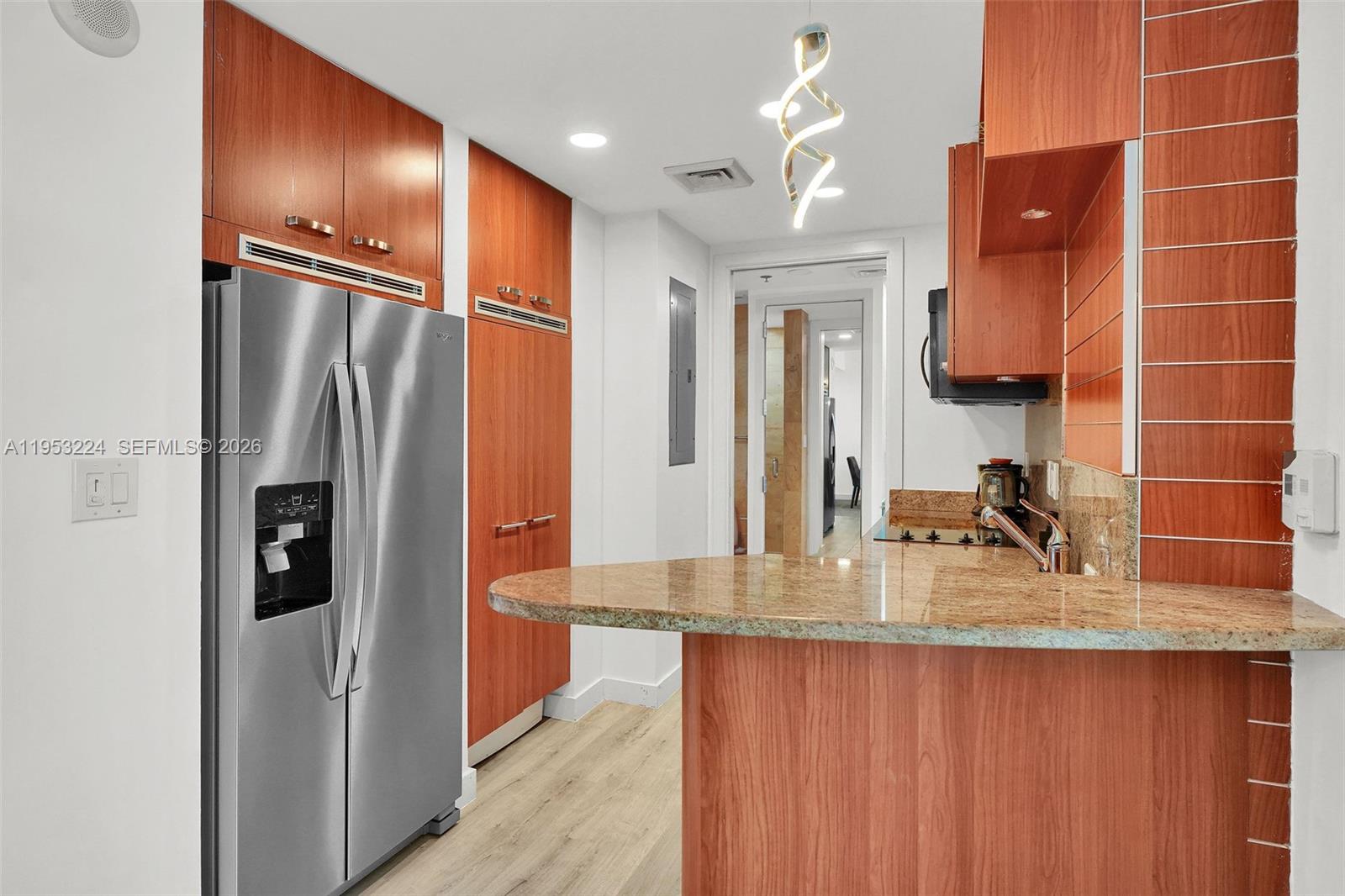 1395 Brickell Avenue, Unit 3311 Miami, FL 33131 - Photo 11 of 40 a bathroom with a granite countertop sink a mirror and shower