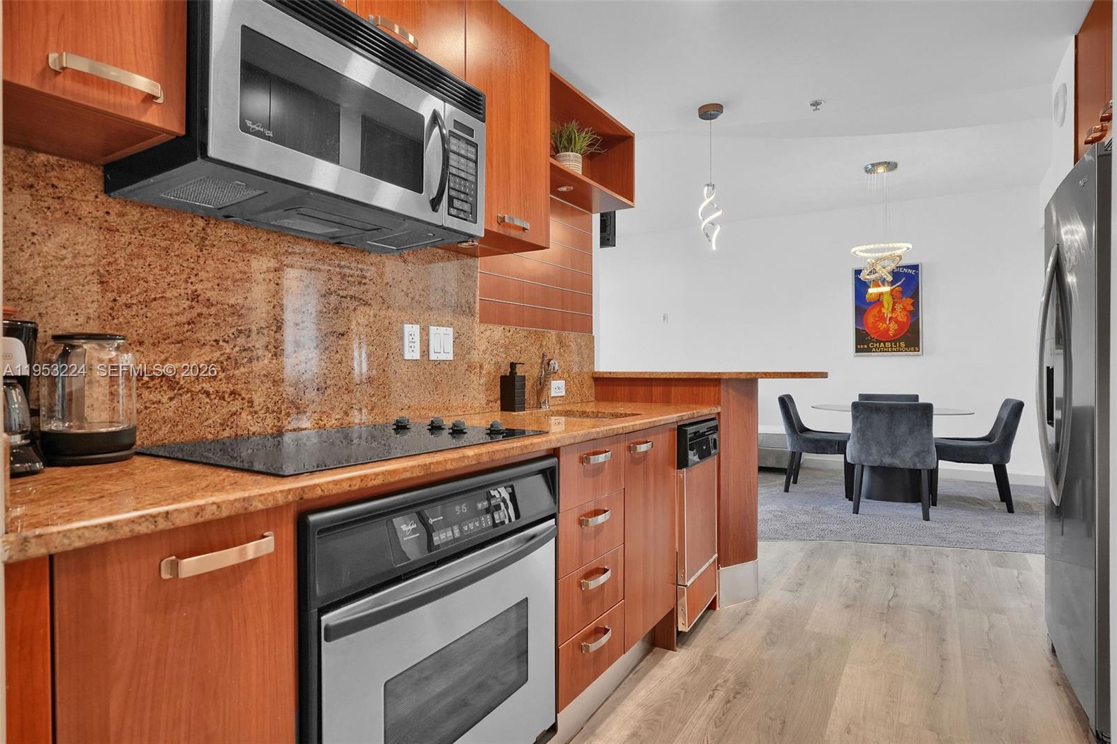 1395 Brickell Avenue, Unit 3311 Miami, FL 33131 - Photo 14 of 40 a kitchen with stainless steel appliances kitchen island a stove a sink and a microwave