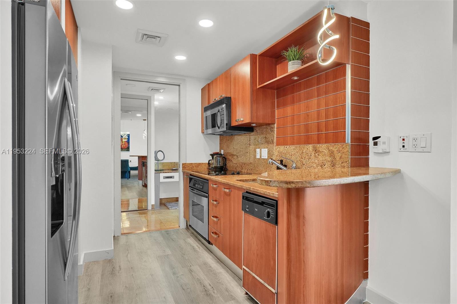 1395 Brickell Avenue, Unit 3311 Miami, FL 33131 - Photo 15 of 40 a kitchen with stainless steel appliances granite countertop a stove and a refrigerator