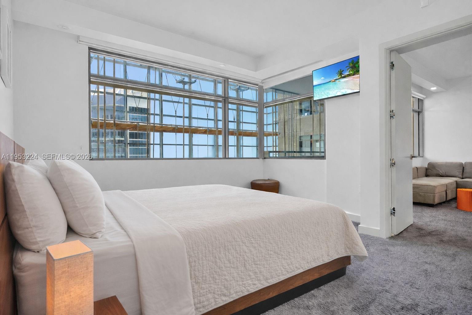 1395 Brickell Avenue, Unit 3311 Miami, FL 33131 - Photo 21 of 40 a bedroom with a bed and a large window