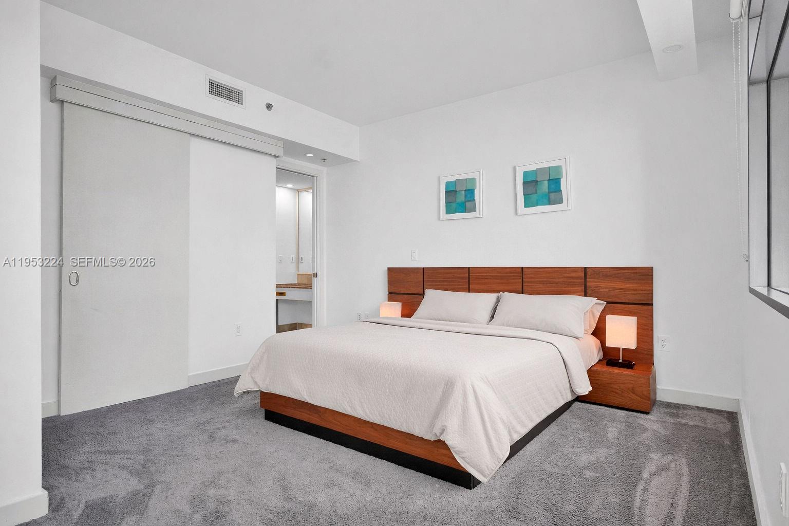 1395 Brickell Avenue, Unit 3311 Miami, FL 33131 - Photo 22 of 40 a bedroom with a bed and window