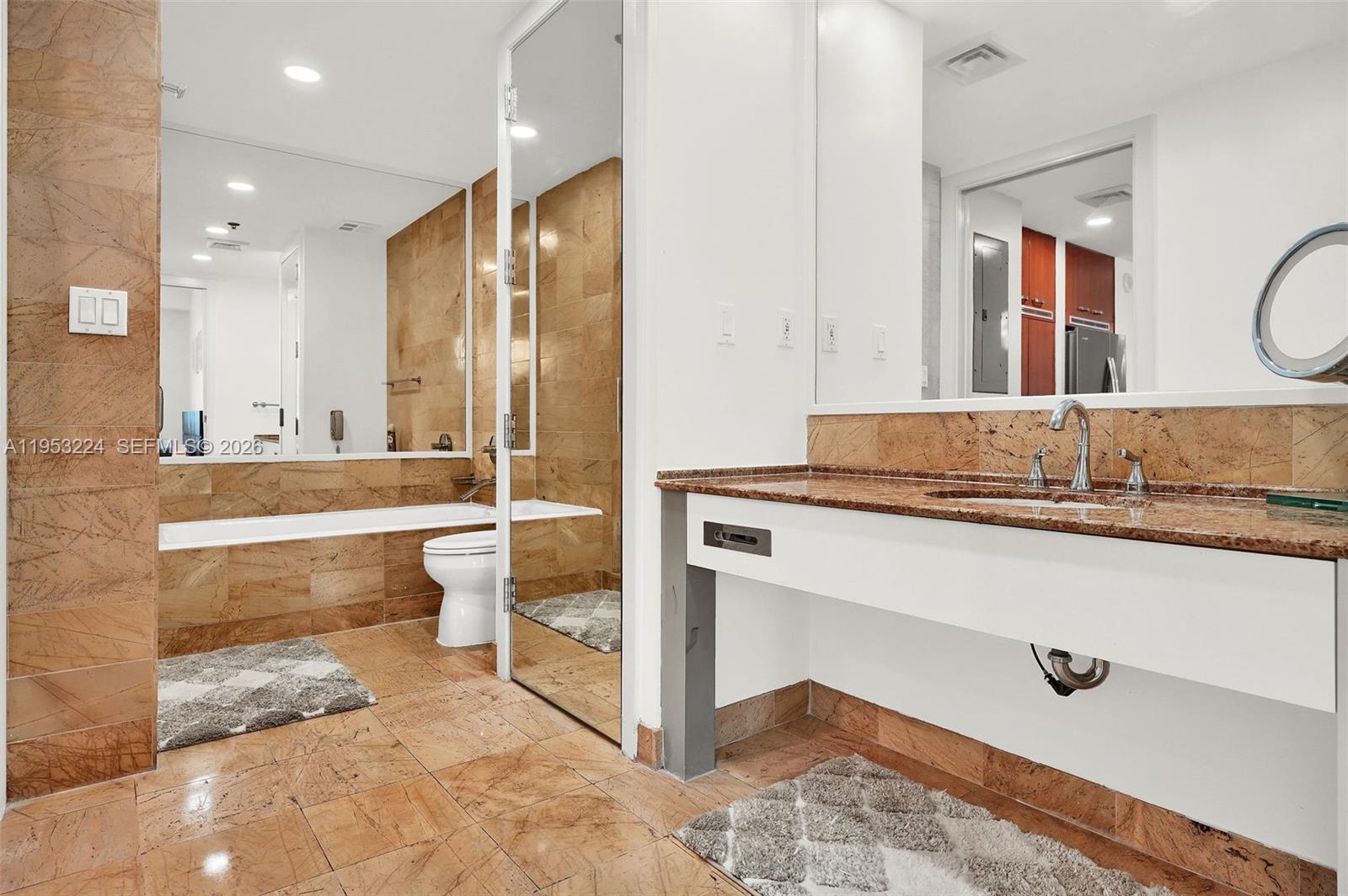 1395 Brickell Avenue, Unit 3311 Miami, FL 33131 - Photo 24 of 40 a bathroom with a double vanity sink mirror and bathtub