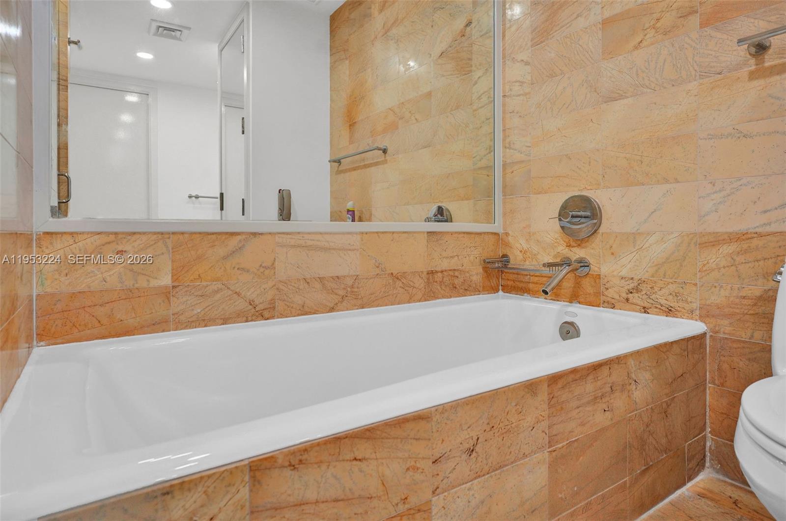 1395 Brickell Avenue, Unit 3311 Miami, FL 33131 - Photo 27 of 40 a bathroom with a bathtub and a toilet