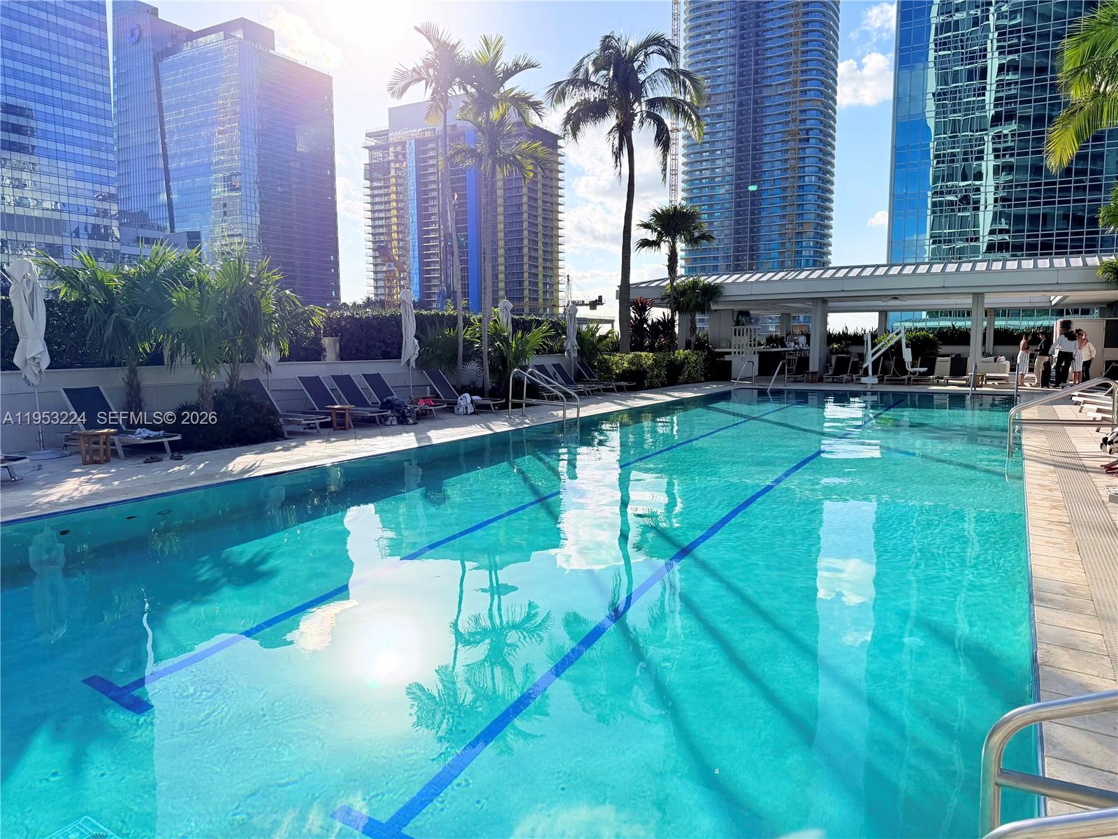 1395 Brickell Avenue, Unit 3311 Miami, FL 33131 - Photo 39 of 40 a house view with a swimming pool and outdoor seating