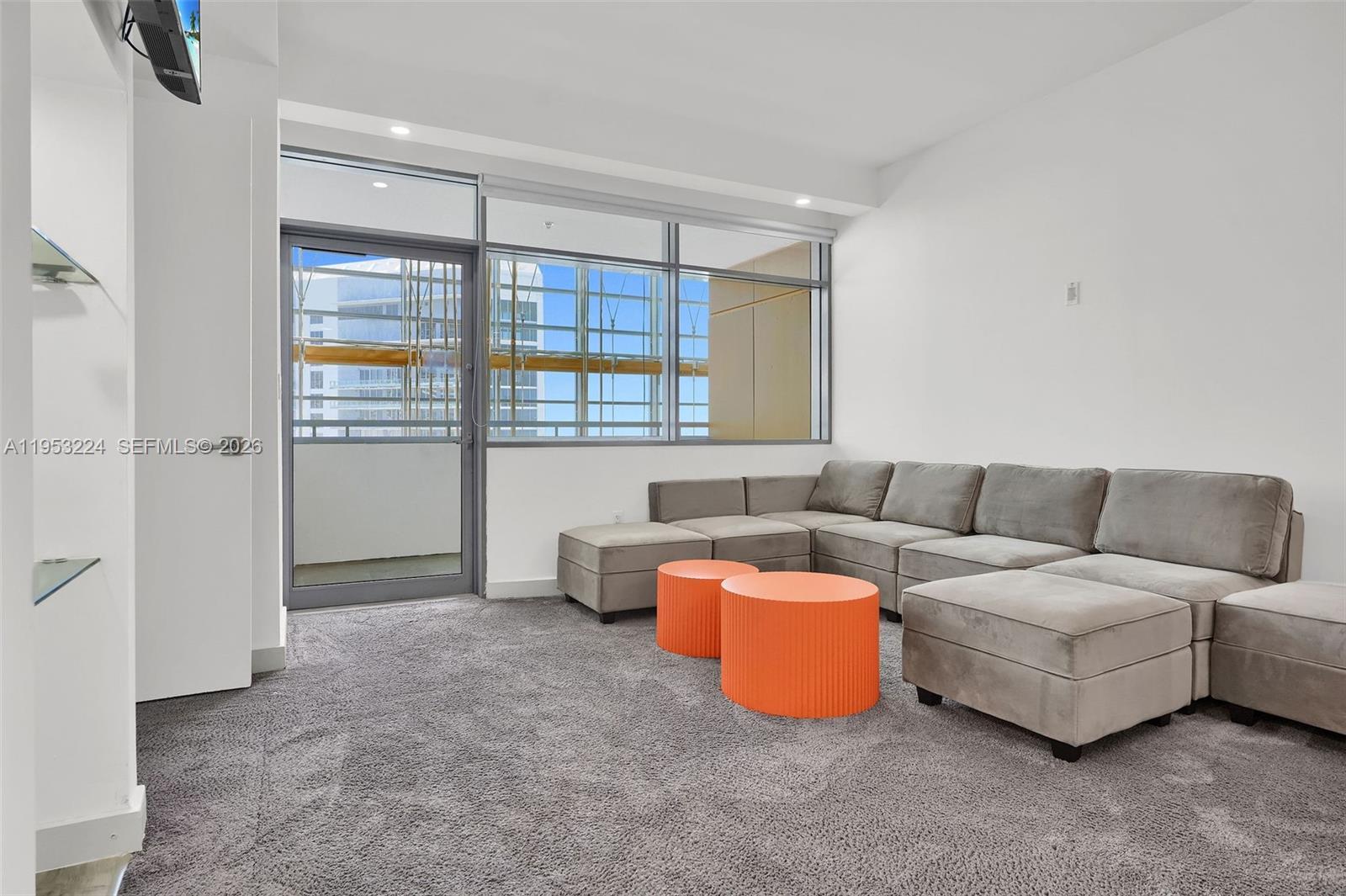 1395 Brickell Avenue, Unit 3311 Miami, FL 33131 - Photo 6 of 40 a living room with furniture and a window
