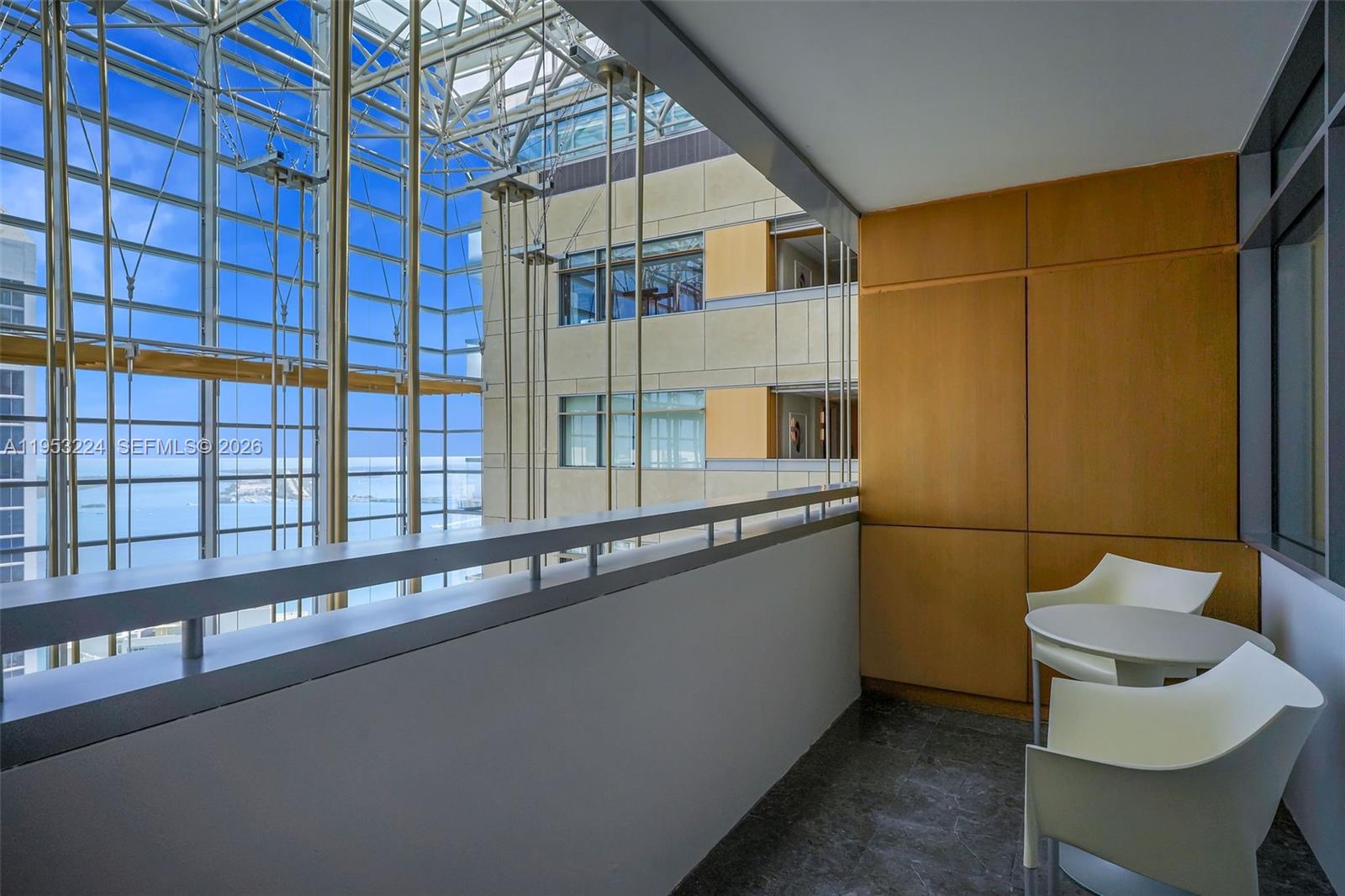 1395 Brickell Avenue, Unit 3311 Miami, FL 33131 - Photo 7 of 40 a view of a balcony with chairs