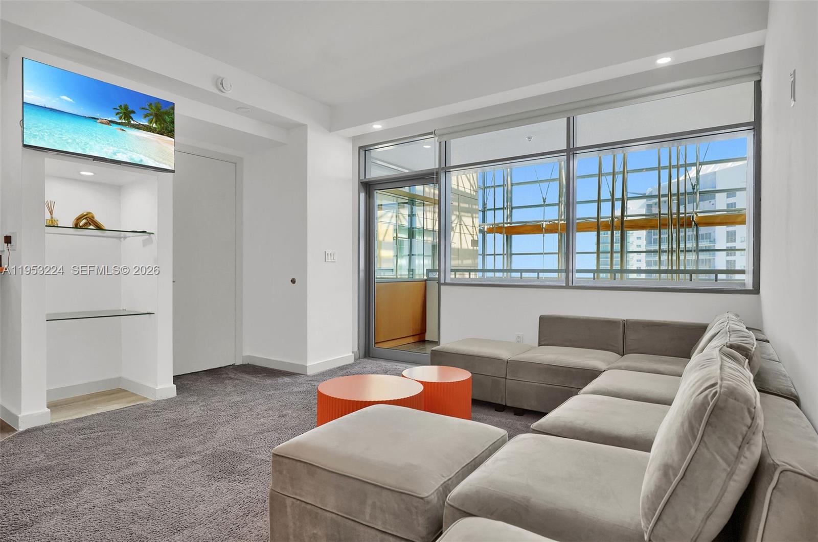 1395 Brickell Avenue, Unit 3311 Miami, FL 33131 - Photo 9 of 40 a living room with furniture and a window