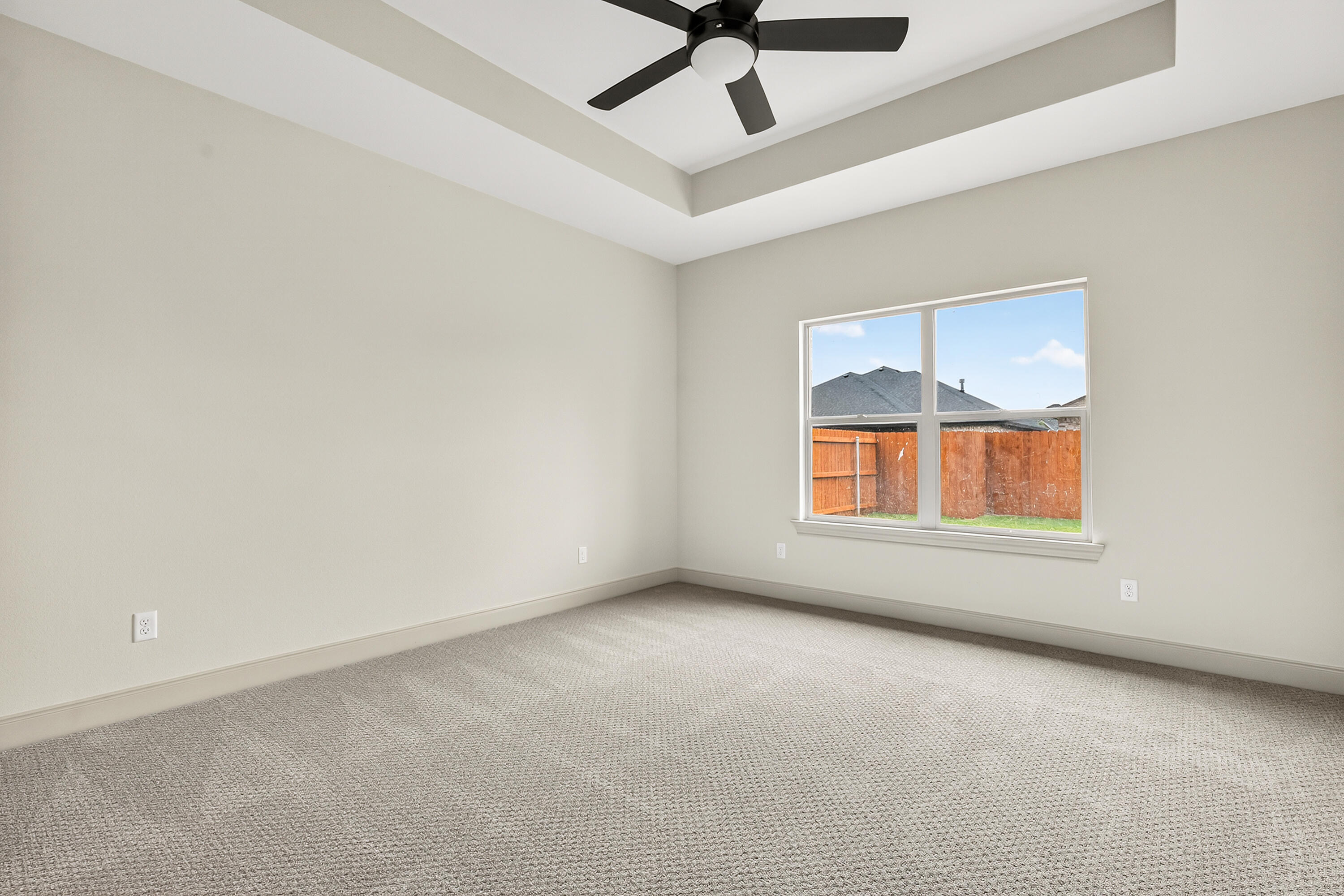 3627 119th Street Lubbock, TX 79423 - Photo 18 of 37 an empty room with a ceiling fan and windows