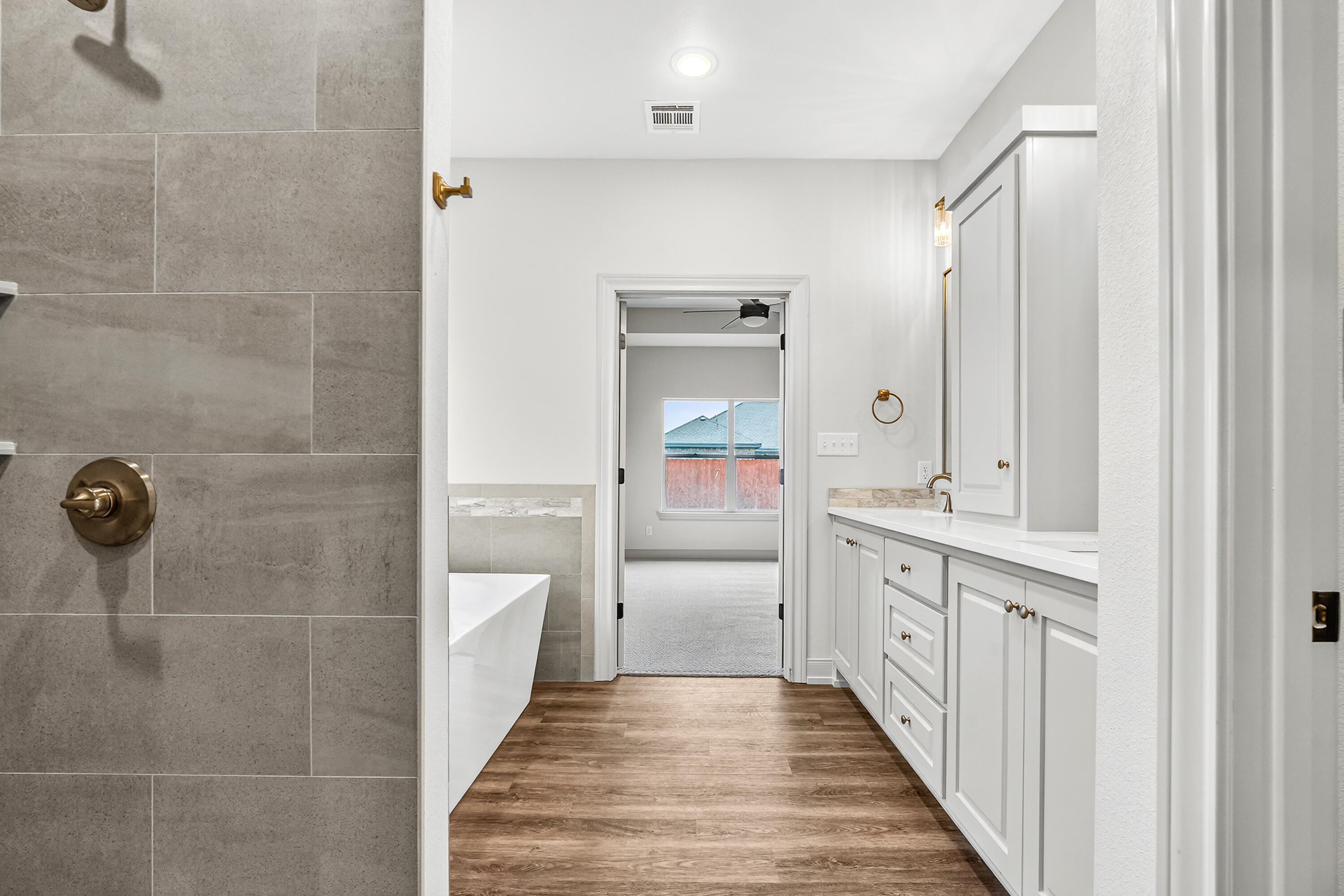 3627 119th Street Lubbock, TX 79423 - Photo 21 of 37 a bathroom with a sink a toilet and shower