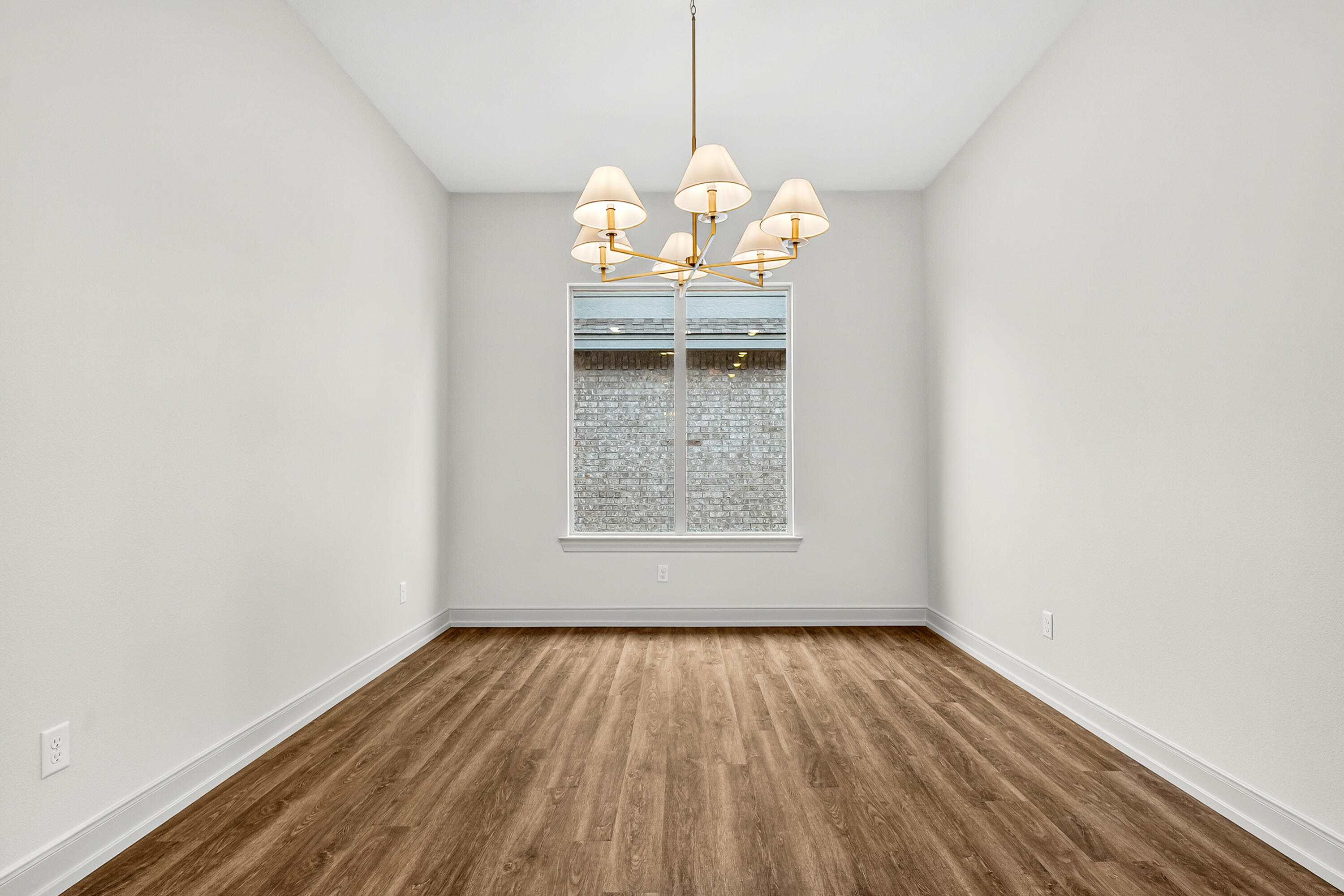 3627 119th Street Lubbock, TX 79423 - Photo 5 of 37 an empty room with wooden floor and windows