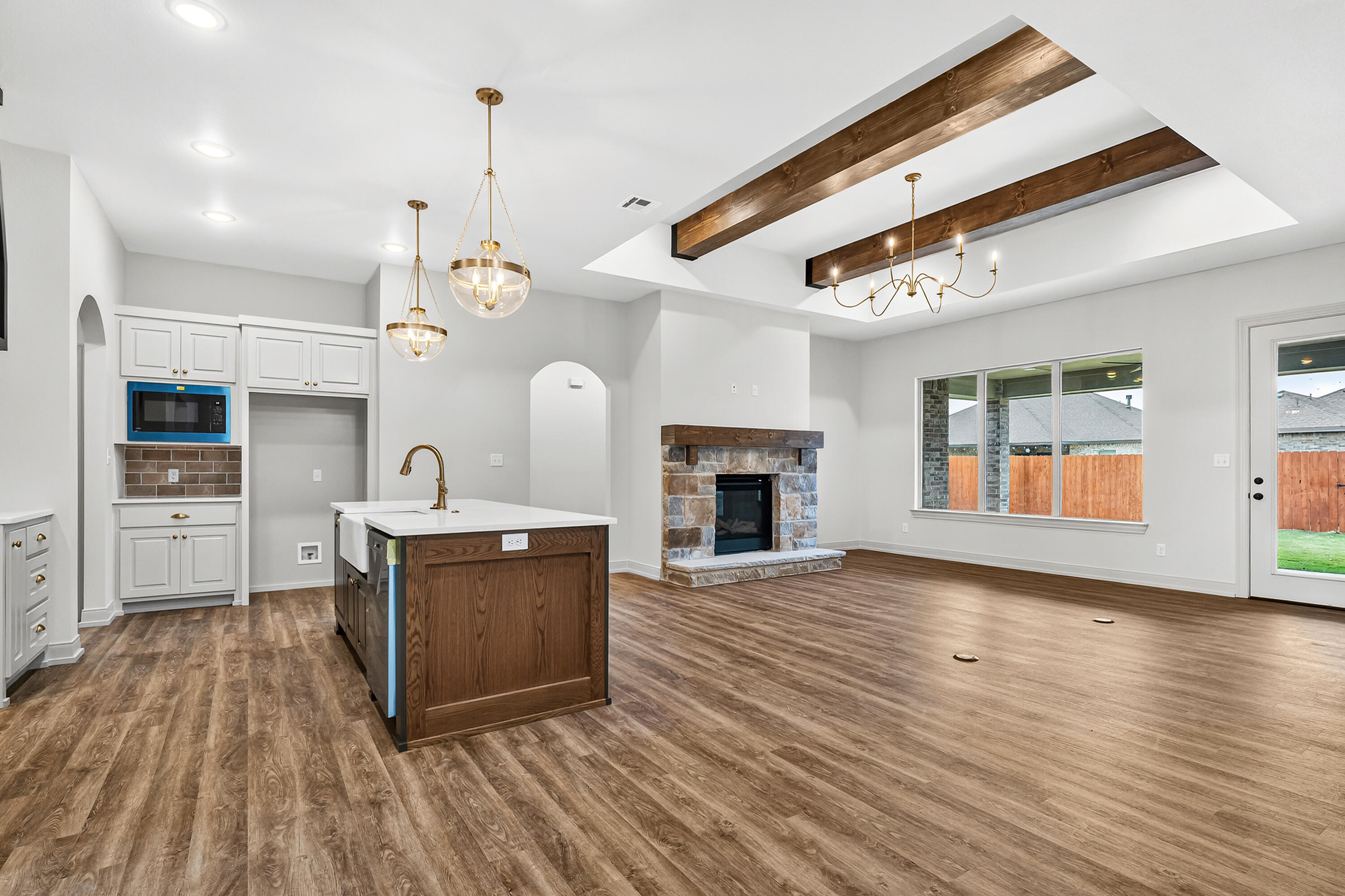 3627 119th Street Lubbock, TX 79423 - Photo 6 of 37 a view of a kitchen with a sink and a fireplace