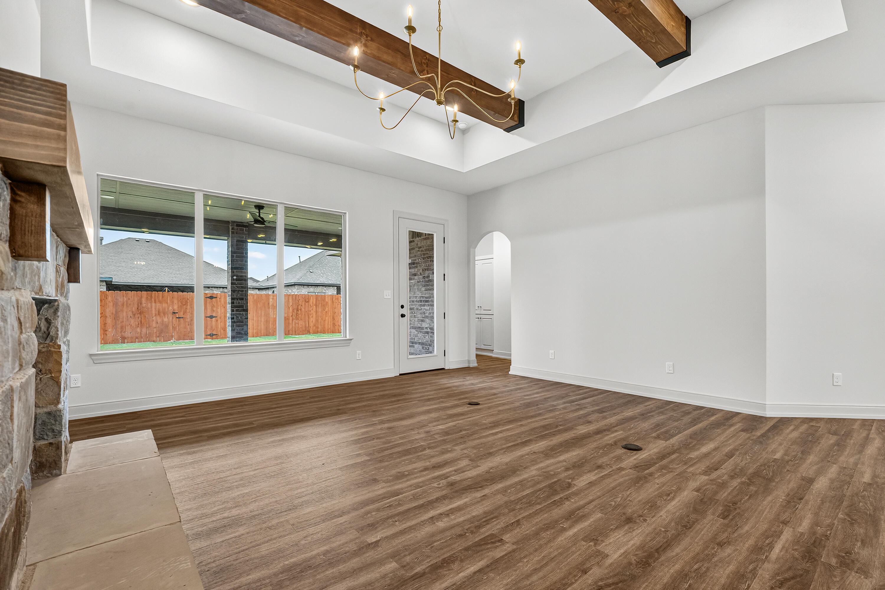 3627 119th Street Lubbock, TX 79423 - Photo 10 of 37 an empty room with wooden floor and windows