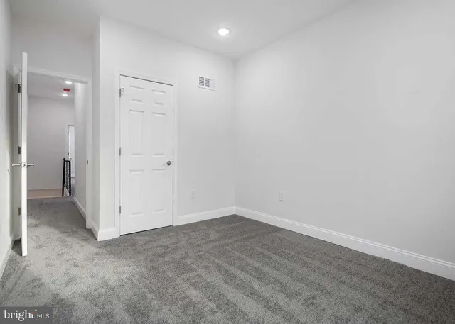 an empty room with a kitchen