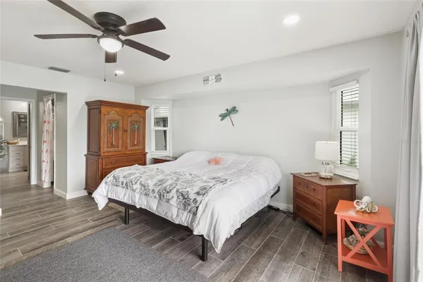 a bedroom with a bed and wooden floor