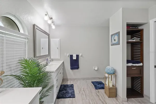 a spacious bathroom with a granite countertop sink and a mirror
