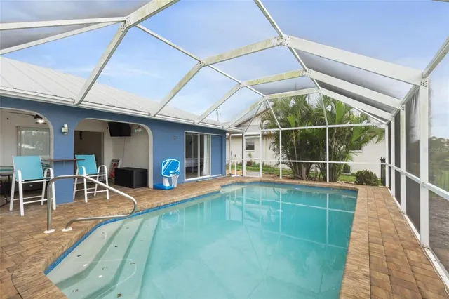 a view of a patio with table and chairs next to a yard
