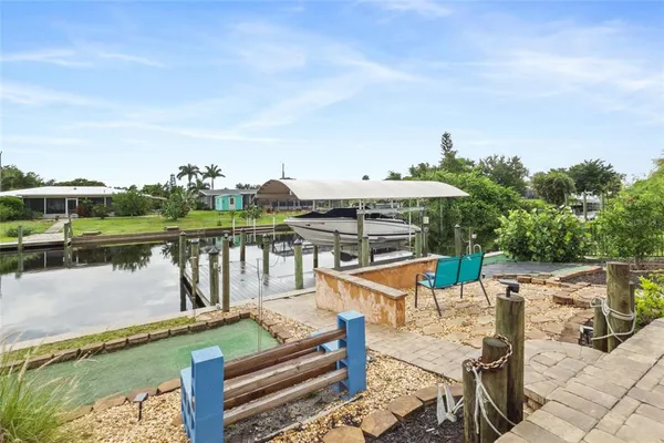 a view of a lake with couches of wooden floor and lake view